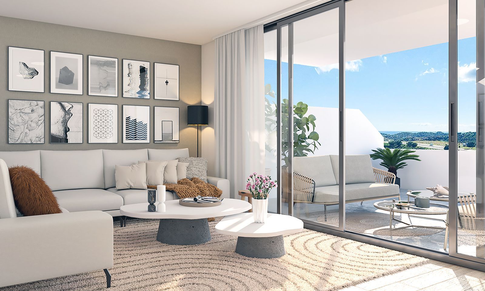 Modern living room with white sofa, gallery wall, and large glass doors opening to a balcony with scenic mountain views.